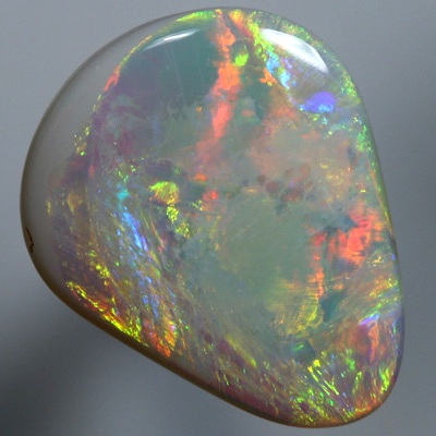 SOLID SEMI BLACK OPAL Large opal with rolling flasehs of orange SEE VIDEO